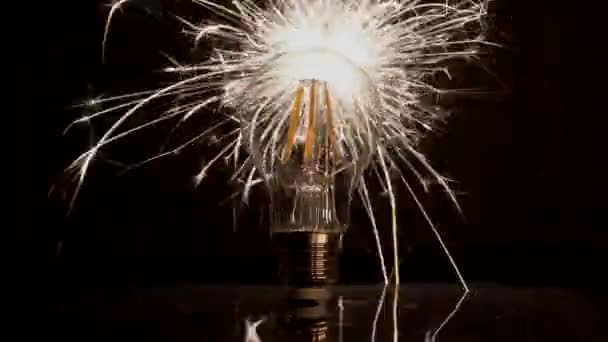 Sparkler Behind LED Light Bulb - Fast Long Sparks. — Stock Video