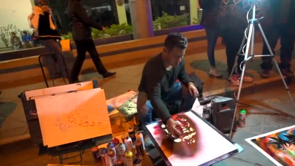 Cuenca, Ecuador - 20180602 - artistas - cámara lenta - artista de pintura en aerosol rocía sobre plantilla. — Vídeos de Stock