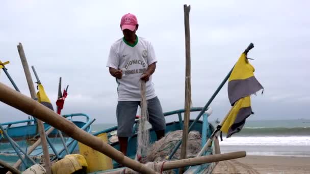 San Pedro, Ecuador - 20180915 - Man Stands in Boat As He Fixes Net. — Stock Footage San Pedro, Ecuador - 20180915 - Man Stands in Boat As He Fixes Net. Stock Footage