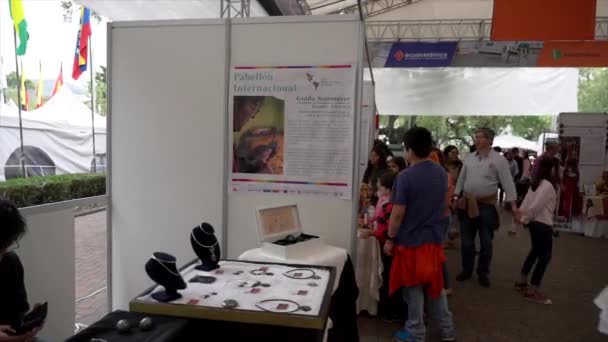 Cuenca, Équateur - 20181003 - Festival de la fête de l'indépendance de Cuenca Timelapse - Pan of Back Rows of Busy Vendor Tent Pavilion Débute avec un fabricant de bijoux . — Video