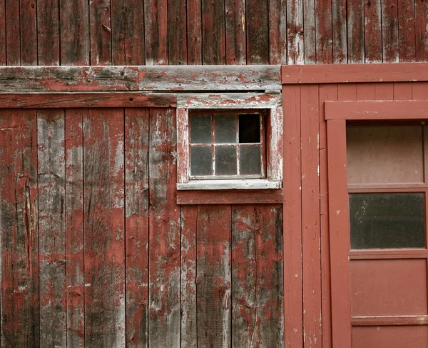 Weathered red paint and broken windows are a common site on barns