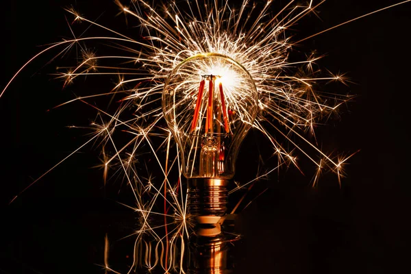 Fireworks sparkler showing through LED light bulb — Stock Photo, Image