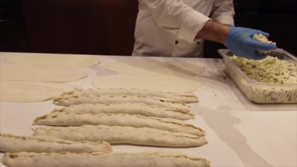 Making Turkish Style Pide step 2 filling the dough — Stock Video