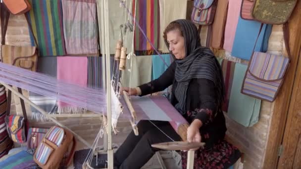 Isfahan, Iran - 2019-04-12 - Young Woman Weaves Cloth 3 - Side View — Stock Video