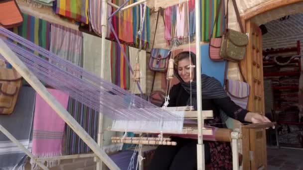 Isfahan, Iran - 2019-04-12 - Young Woman Weaves Cloth 1 - Low View — Stock Video