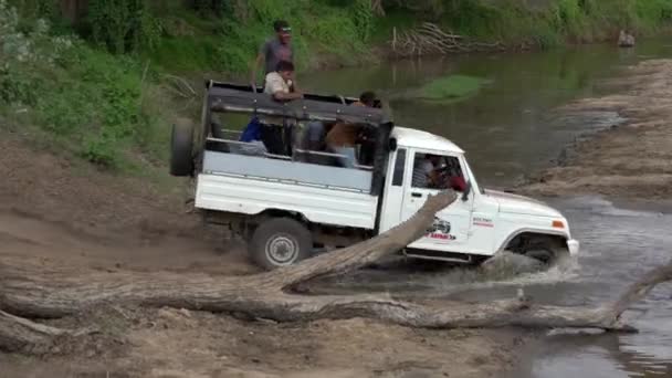 Minneriya National Park, Sri Lanka-2019-03-23-vit Jeep passerar lastbil fastnat i floden — Stockvideo