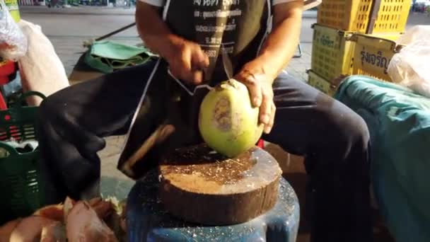 Пхаяо, Таиланд - 2019-03-08 - Food Vendor Cuts Coconut Open Closeup — стоковое видео