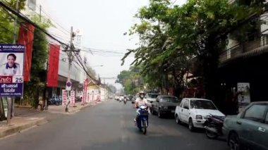 Chiang Mai, Tayland - 2019-03-15 - Motorcyles Drive Down Small Street As Seen From Front From