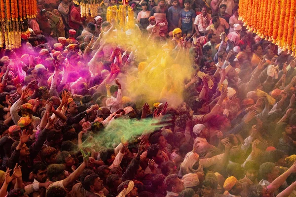 Crowds can be seen below duirng Holi Festival in India, throwing powdered paint — Stock Photo, Image