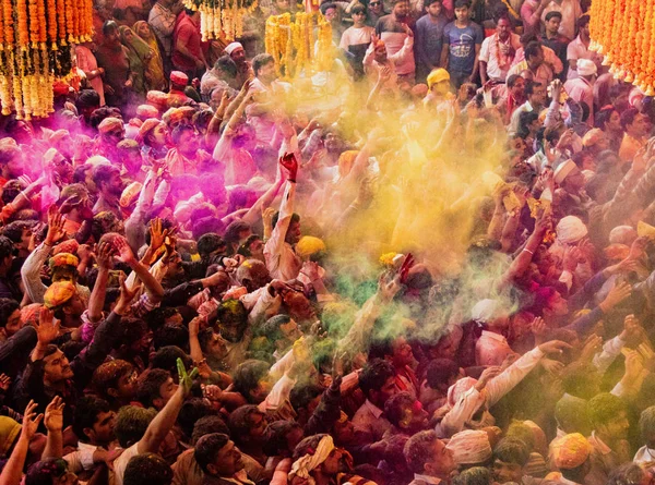 Crowds can be seen below duirng Holi Festival in India, throwing powdered paint — Stock Photo, Image