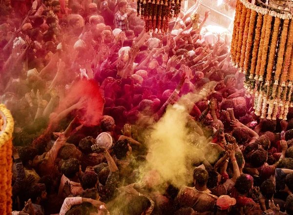 Crowds can be seen below duirng Holi Festival in India, throwing powdered paint — Stock Photo, Image
