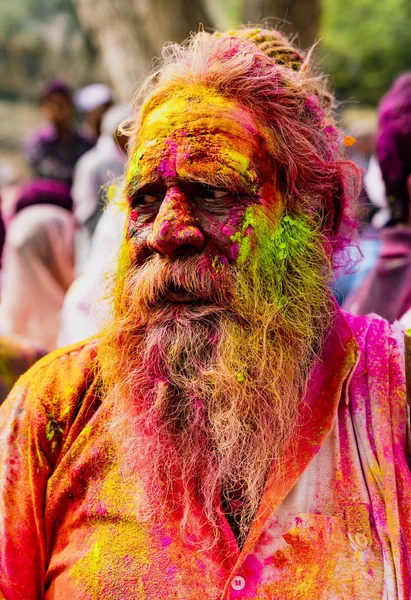 Old man with grey beard covered in Holi paint colors — Stock Photo, Image