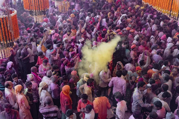 Crowds can be seen below duirng Holi Festival in India, throwing powdered paint — Stock Photo, Image