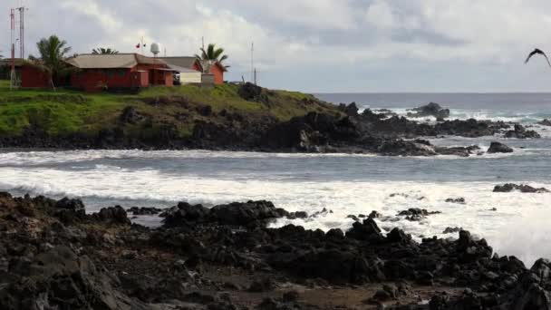 Waves Lap at Coast With Weather Station on Coast — Stock Video