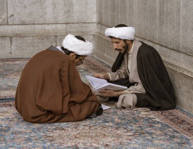 Tehran, Iran - 2019-04-16 - Two holy men study at the Holy Shrine dedicated to Lady Masumeh Fatima clipart