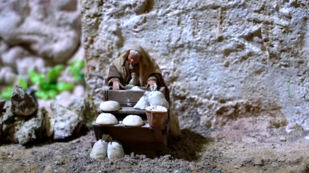 Largest animated nativity scene in South America. Woman makes bread. — Stock Video