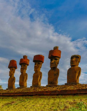 Moai on Easter Island with red topknot hats at Anakena Ahu clipart