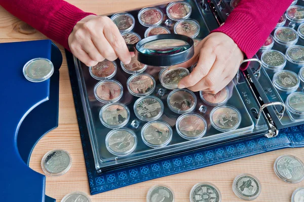 Woman Looks Coins Magnifying Glas Stock Photo by ©Liubomyr