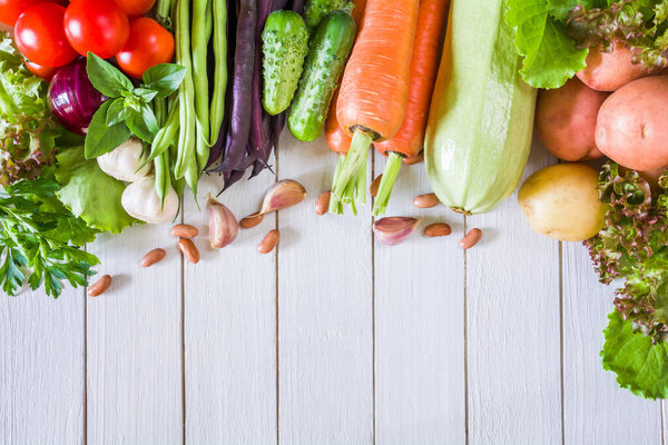 Fresh ripe organic vegetables on a white wooden tabl