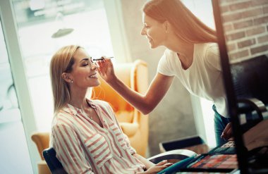 Kadının yüzünde sıvı ton temel uygulama makyaj sanatçısı. Güzellik ve moda kavramı