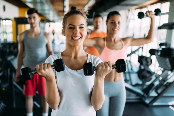 Group of people training in gym together