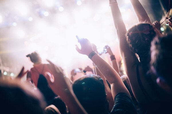 Portrait of happy dancing crowd enjoying at music festival