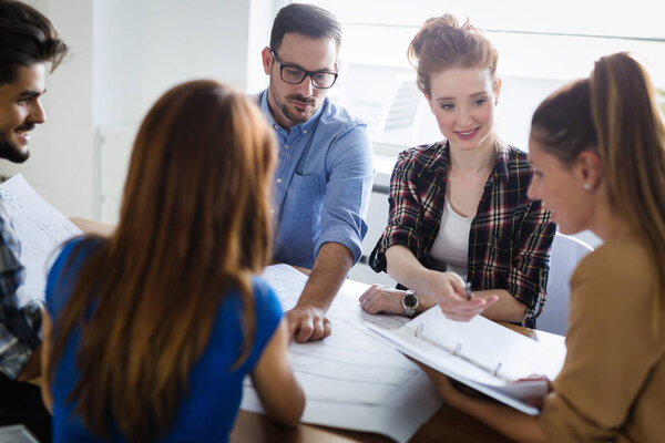 Image of business partners discussing documents and ideas