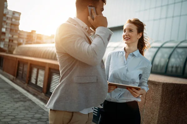 Business people walking and talking in the street