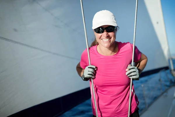 Happy strong sport woman sailing with her boat