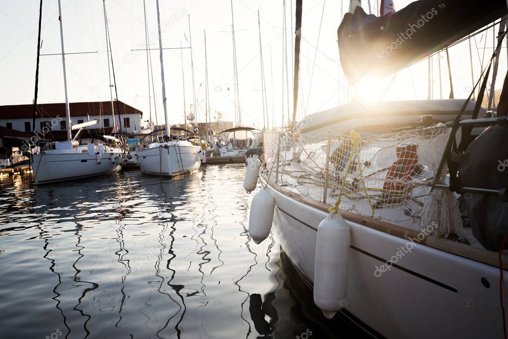 Picture of row of luxury sailboats reflected in water