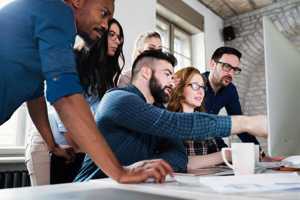 Young architects working on project in office together