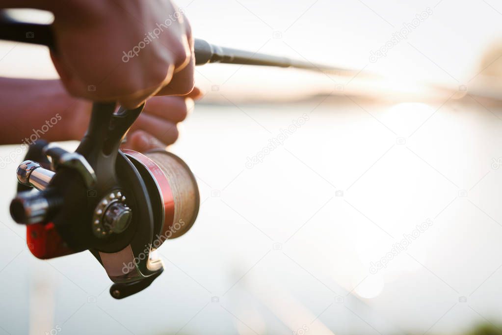 Fishing gear - fishing spinning, fishing line and sports equipment concept