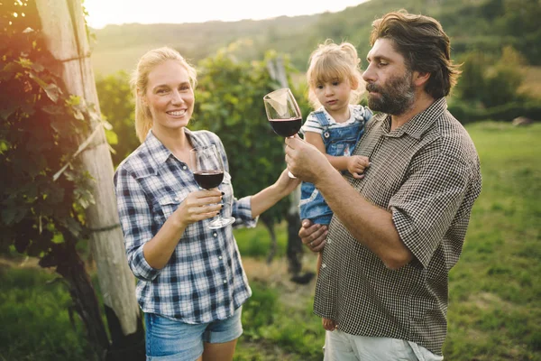 Winegrower family tasting wine