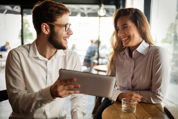 Business people talking and laughing together at cafe