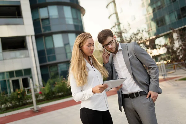 Business people commuting on street and talking