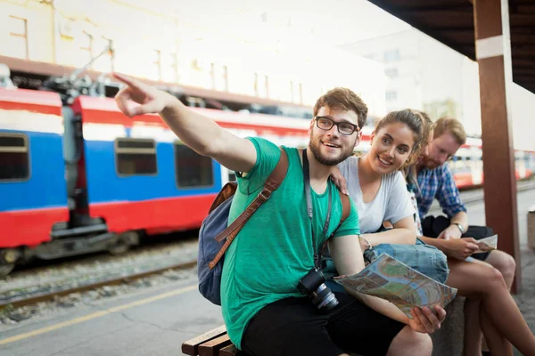 Group of happy tourists traveling by train