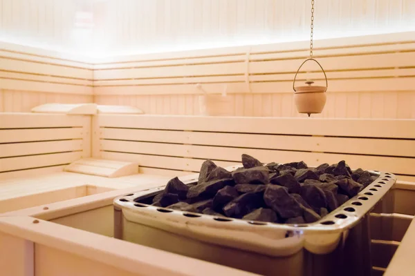 Beautiful sauna interior with heater  and stones