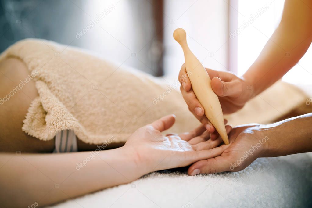 Hand and palm massage by therapist at spa resort