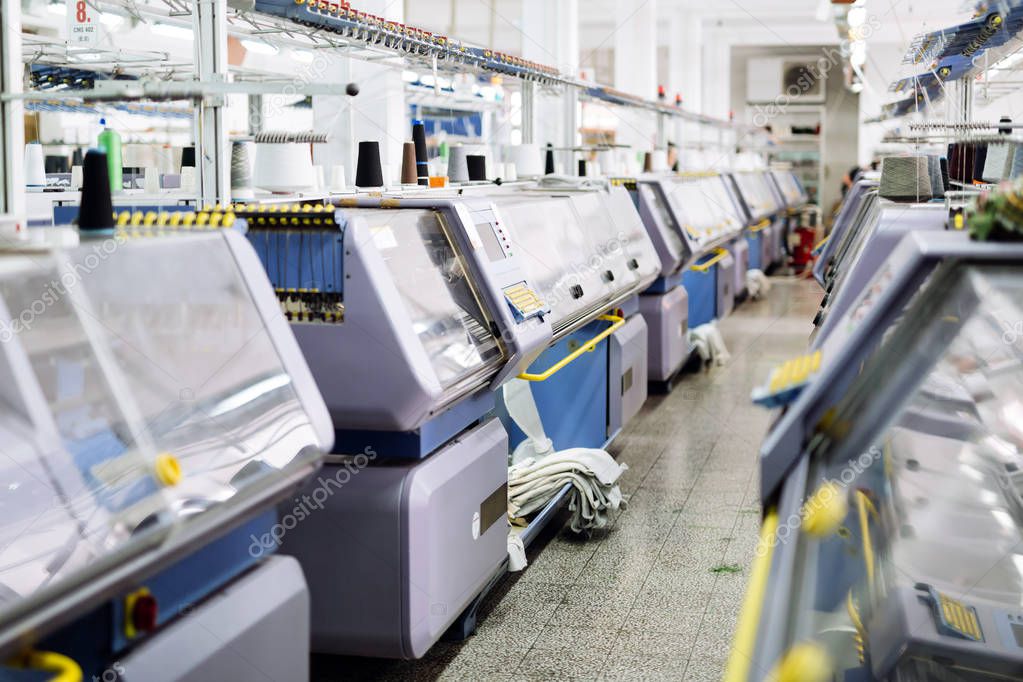 Computerized knitting machines in modern textile factory
