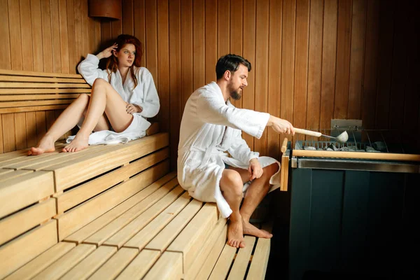 Couple enjoying finnish sauna during their spa weekend