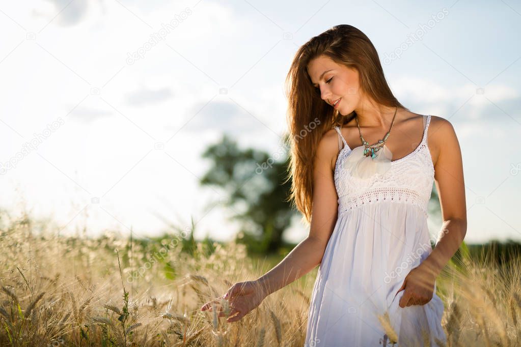 Young beautiful happy woman spending time in nature