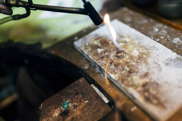 Jeweler working on ring in his workshop