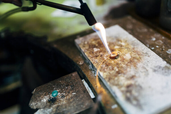 Jeweler working on ring in his workshop