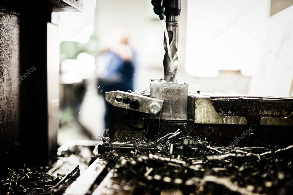 Automated drilling machines processing metalwork for assembly robots