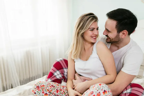 Genç mutlu çift yatak odasında romantik vakit geçiriyor