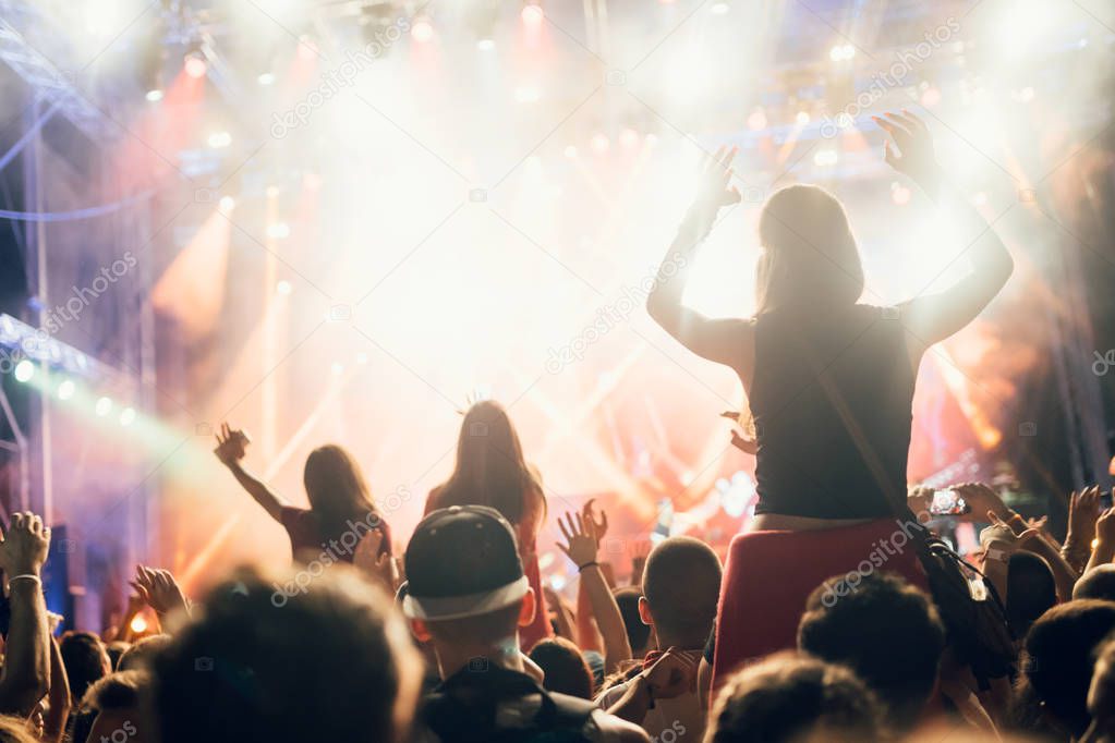 Portrait of happy crowd enjoying and dancing at music festival