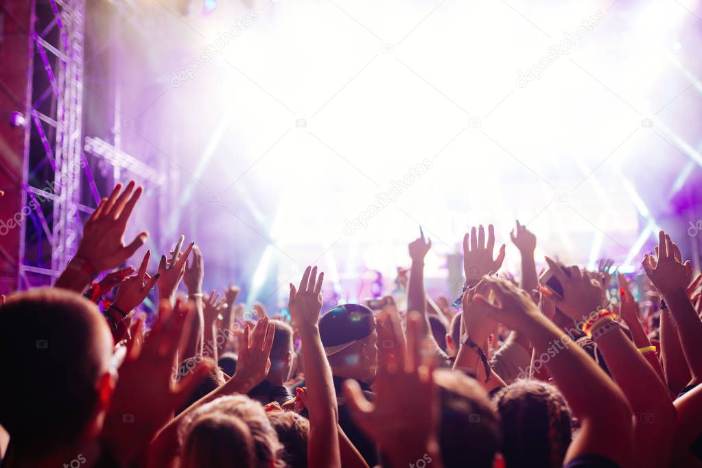 Portrait of happy crowd enjoying and dancing at music festival