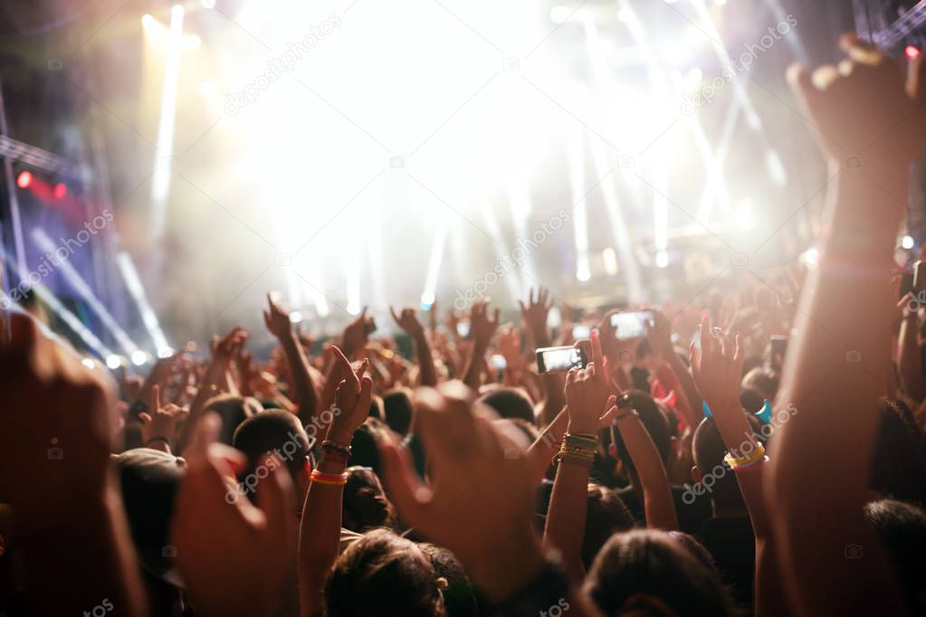 Portrait of happy dancing crowd enjoying at music festival