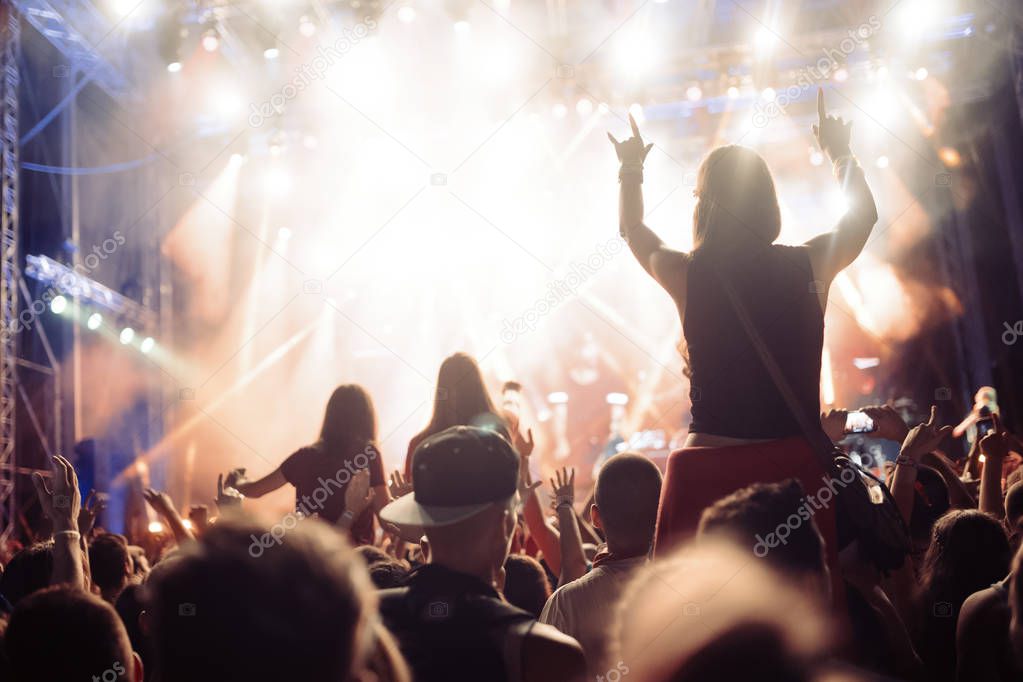 Portrait of happy dancing crowd enjoying at music festival