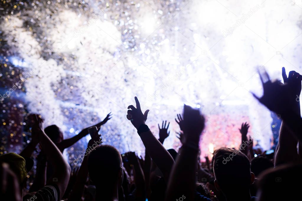 Portrait of happy dancing crowd enjoying at music festival